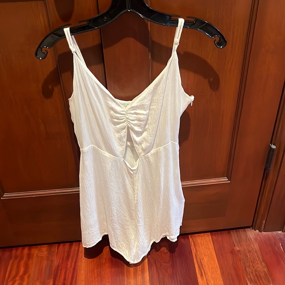 White romper. Size 8. Cutout on front. Zipper on side & clasp. Perfect condition